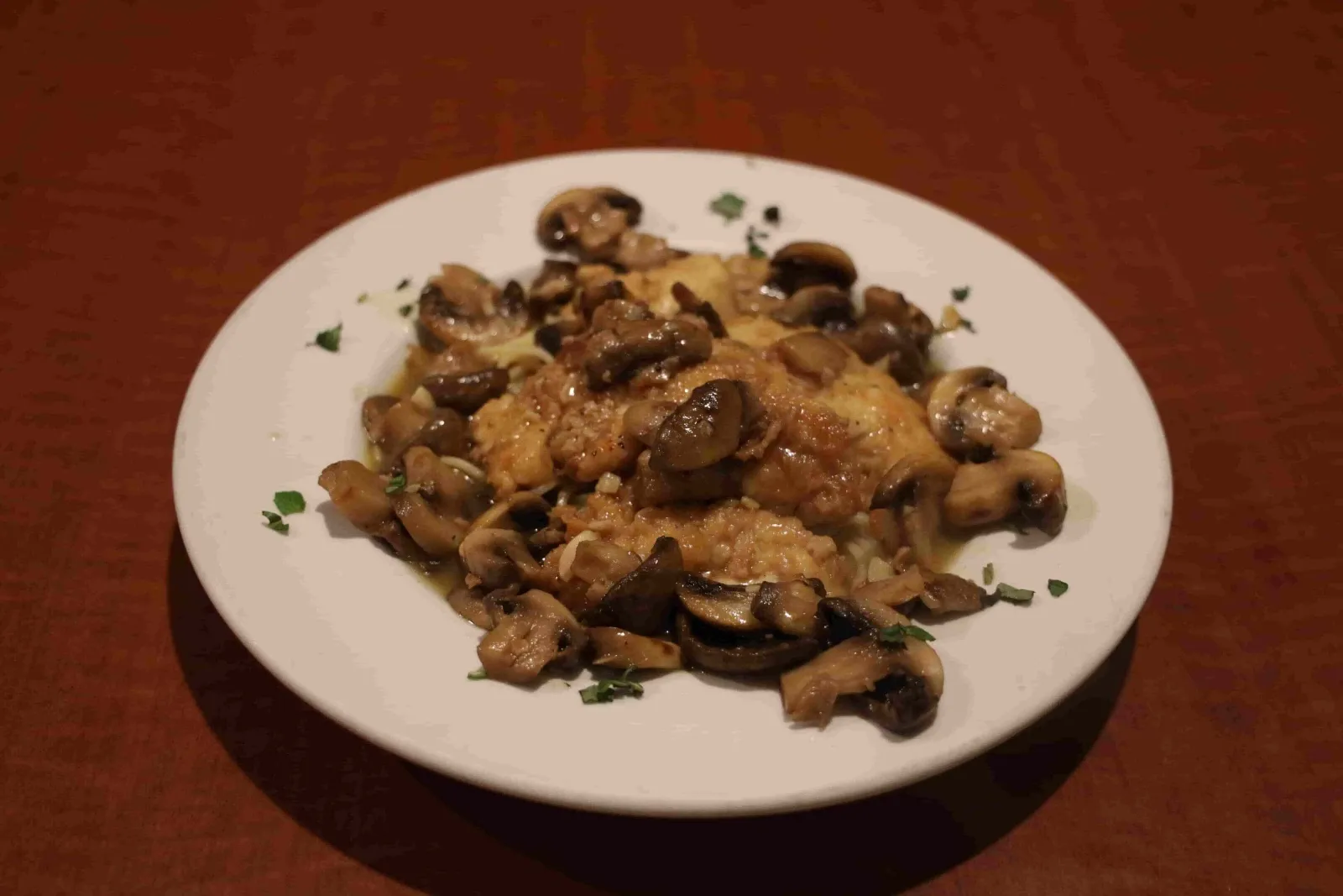 Plate of chicken marsala with mushrooms