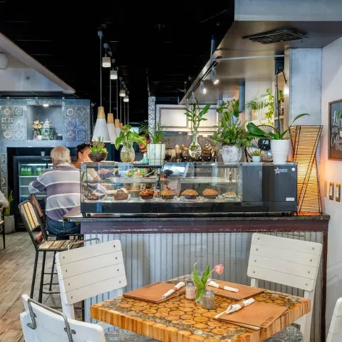 Green Zebra Cafe interior, seating by a display case.