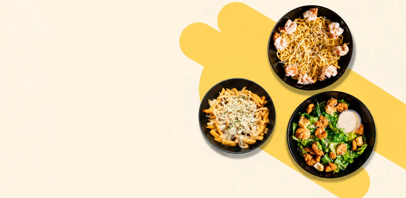 Three black bowls with different pasta and salad dishes on a yellow and white background.