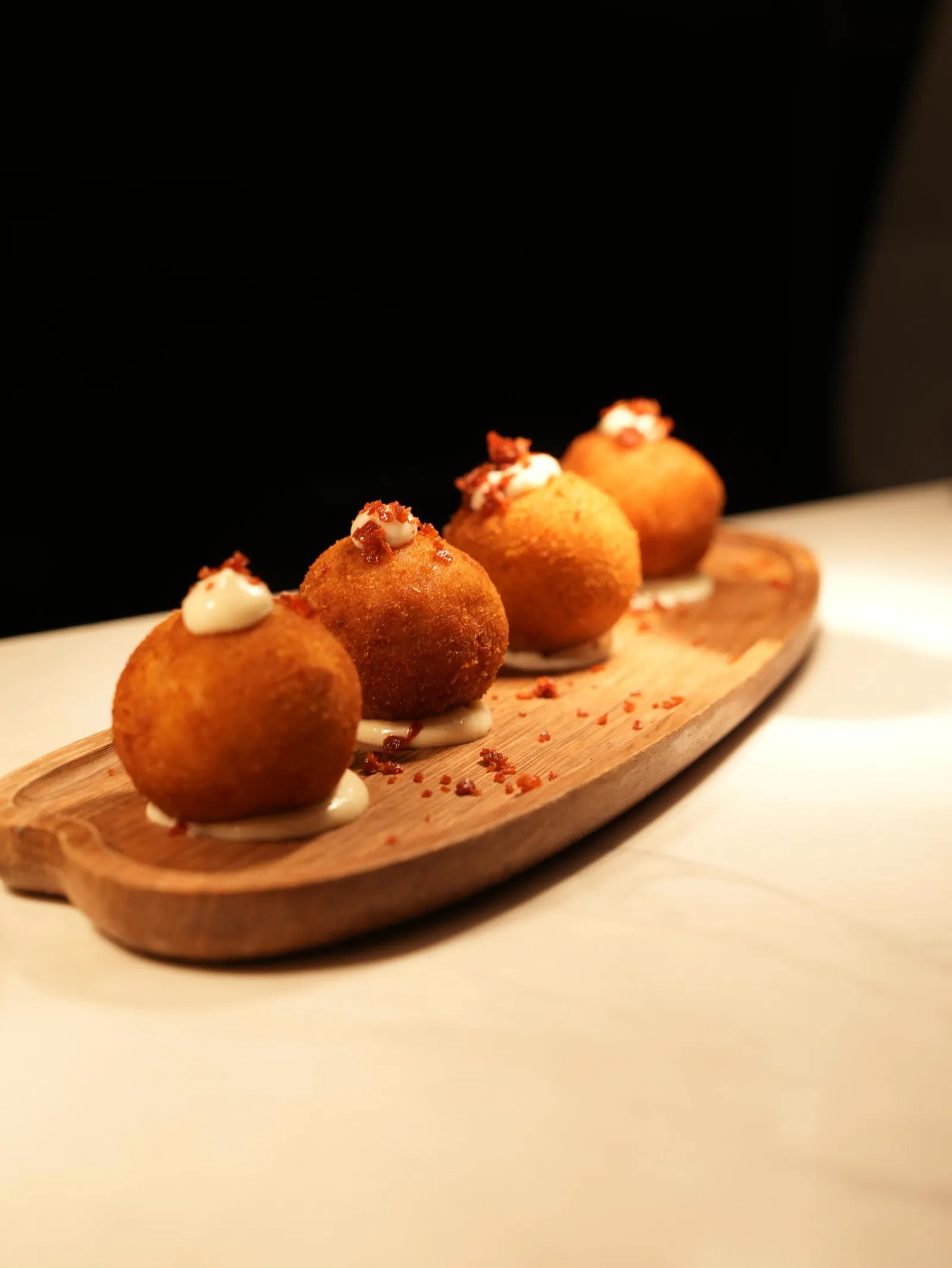 Croquetas served with aioli and crispy jamón at Madrid Tapas y Vinos