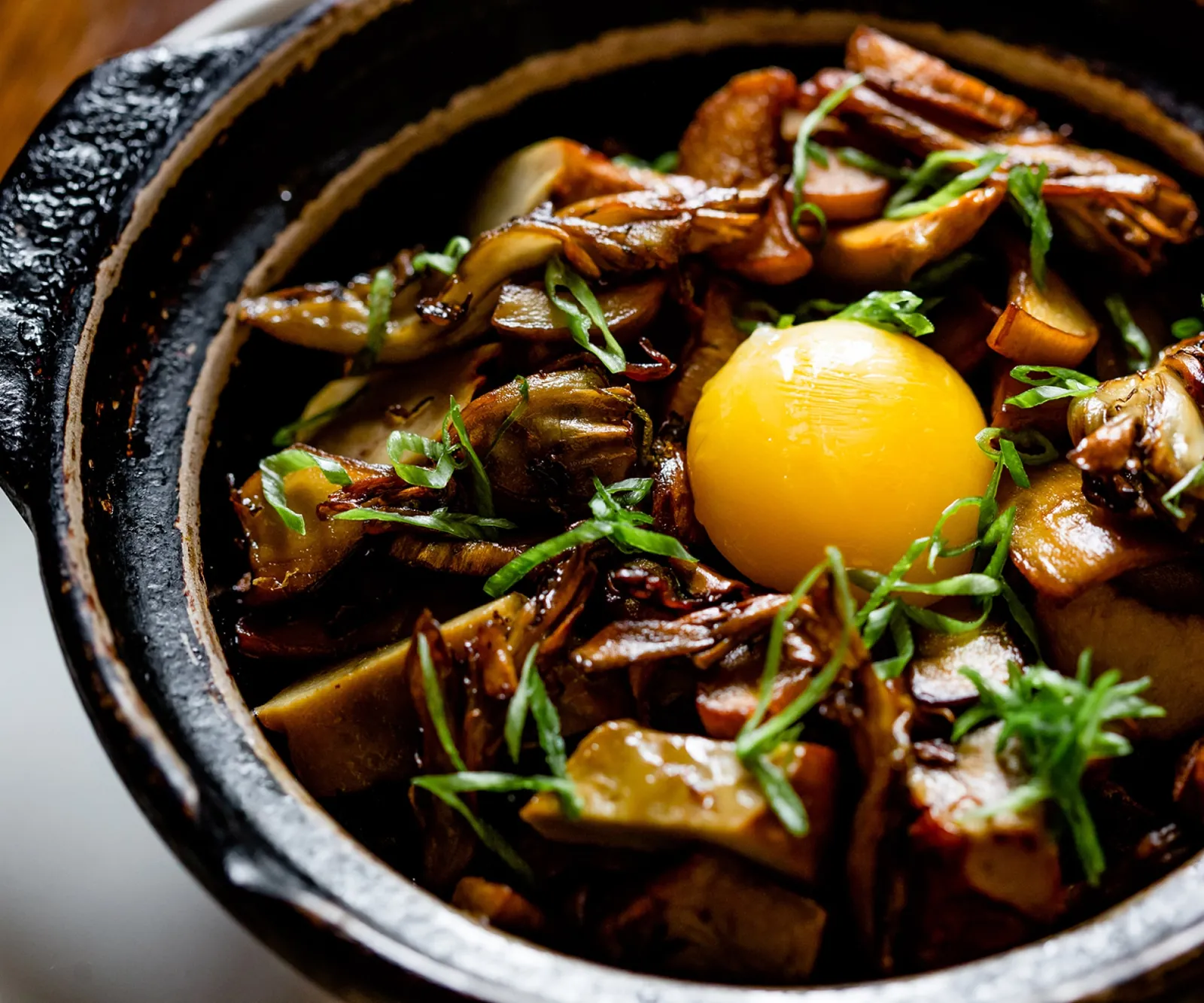 uchi sushi mushroom hot stone pot with egg yolk and scallions