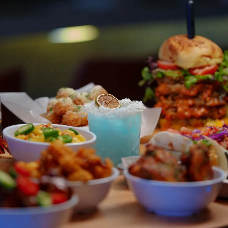 Various dishes served on the table with a cocktail.