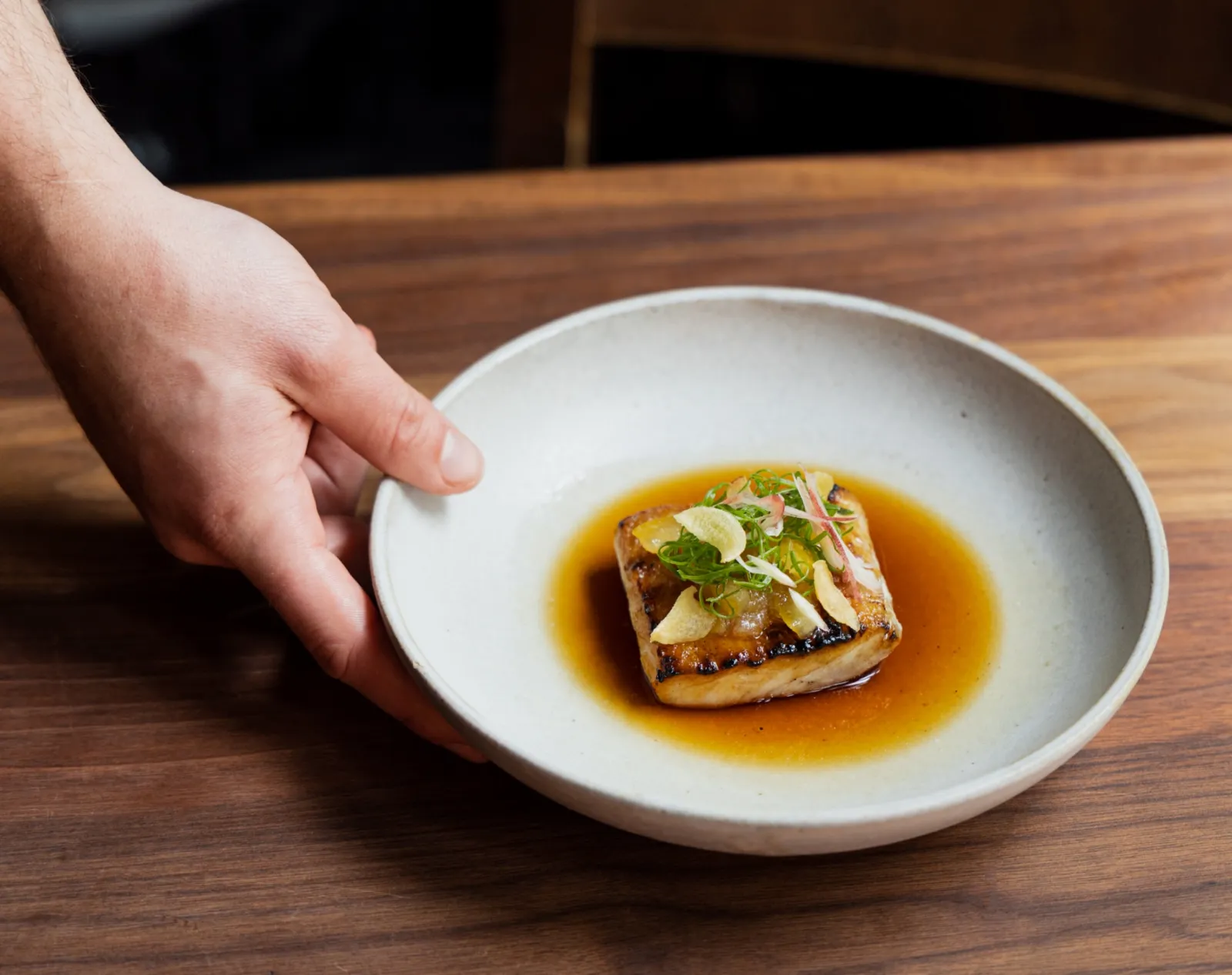 walu walu served in a white bowl at uchi miami sushi restaurant