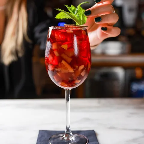 Cocktail glass, bartender light touch with mint leaves