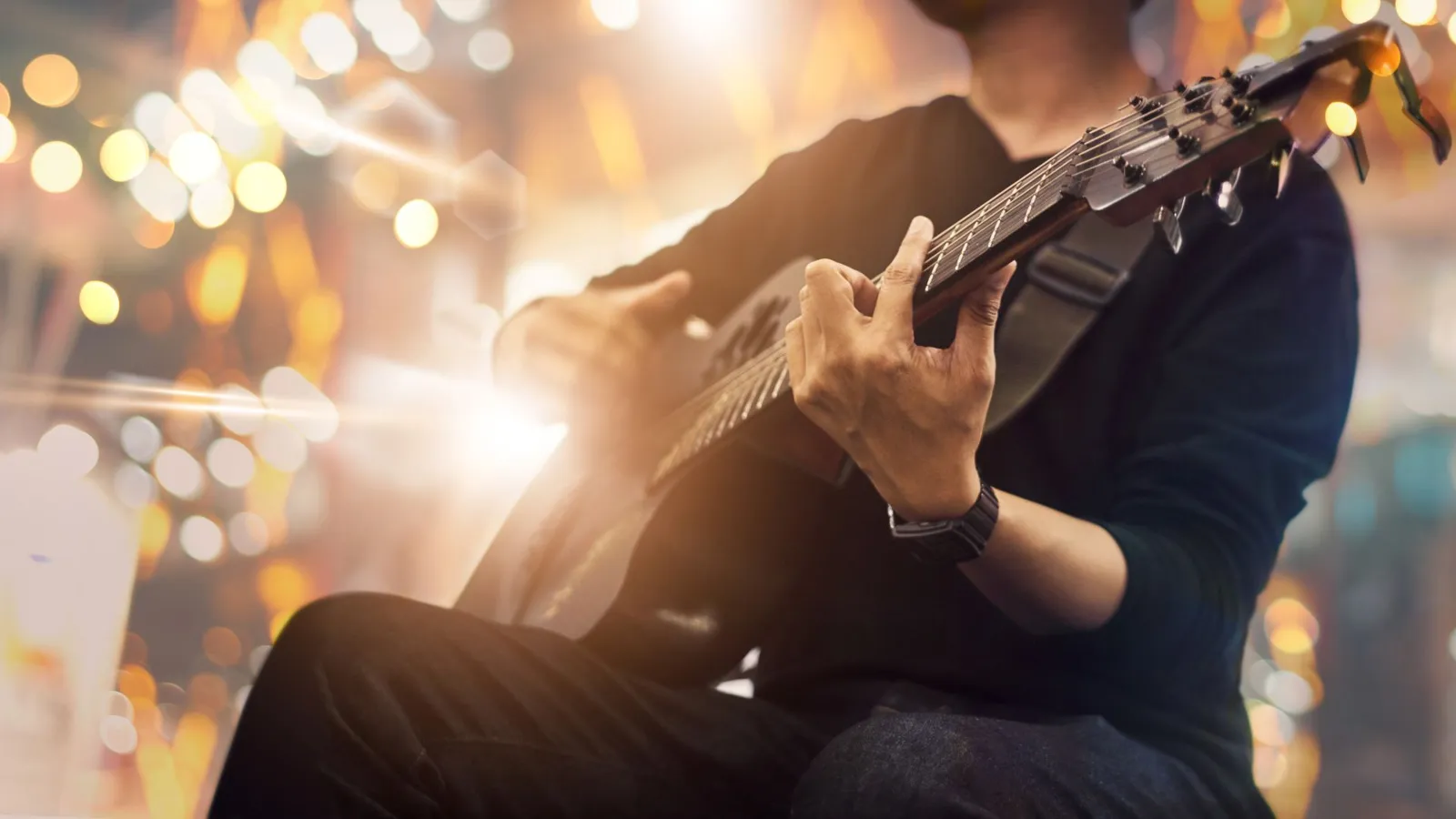 A Person Playing A Guitar