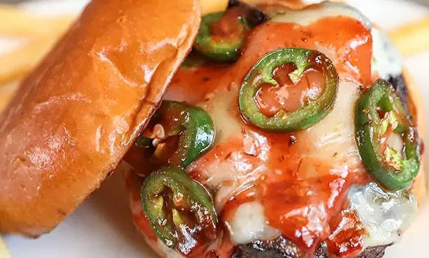 Fresh Angus beef burger with pepperjack cheese, candied short rib and jalapeños then drizzled with our chipotle BBQ sauce on a toasted bun