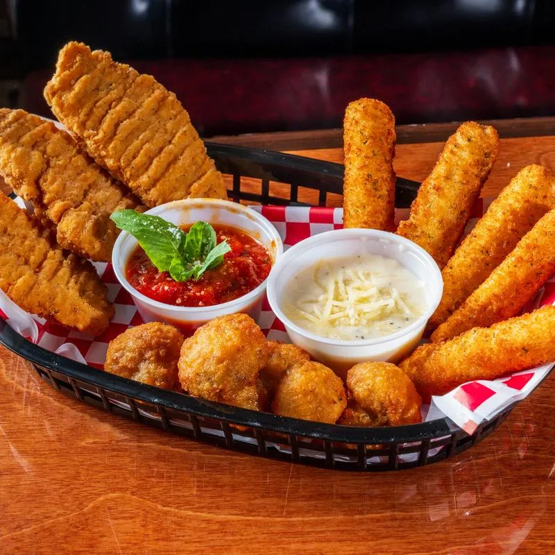 Appetizer basket with fried food, mozzarella sticks, and dipping sauces.