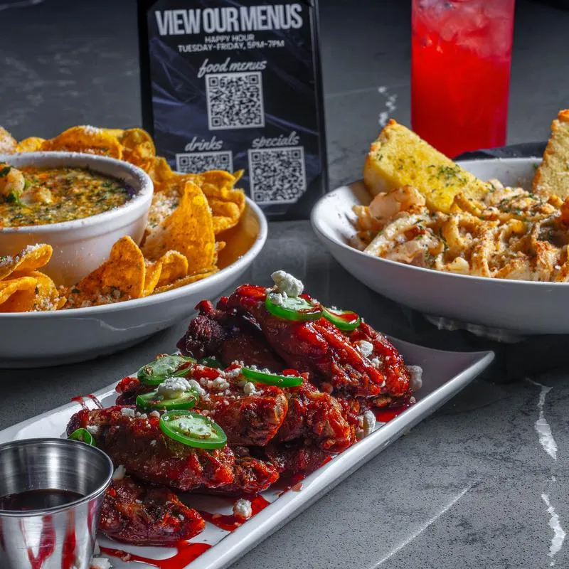 Assortment of dishes served on the table with a cocktail.