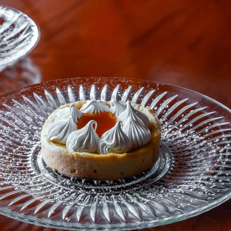 Passion fruit pie on a decorative glass plate.