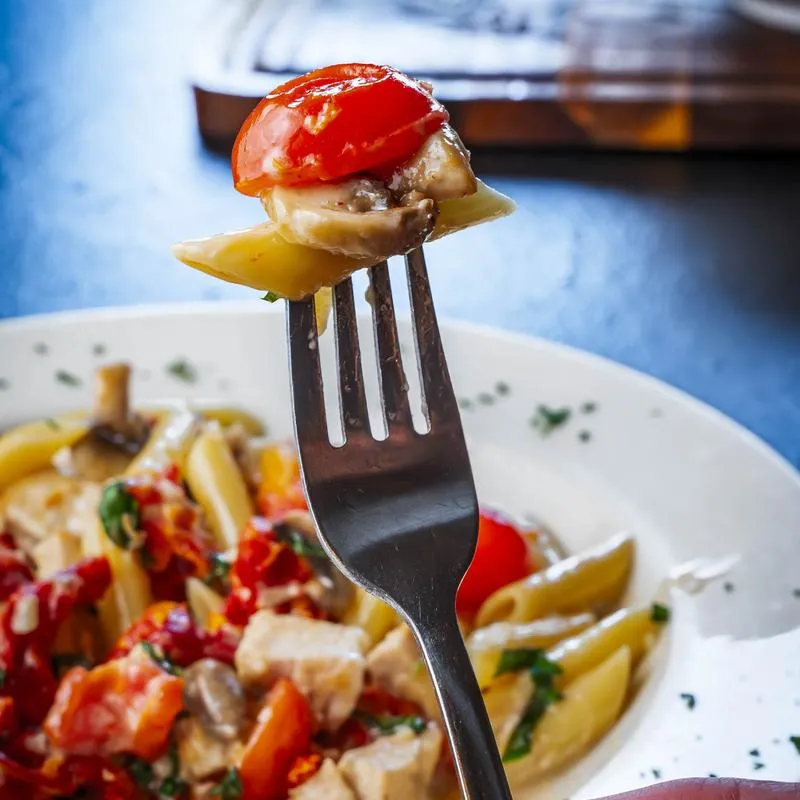 Penne pasta with chicken and tomatoes.