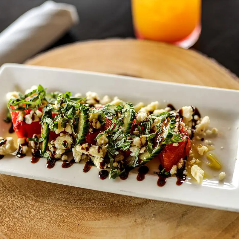 House salad, with tomato, parsley, cheese crumbles, cucumber and balsamic vinaigrette.