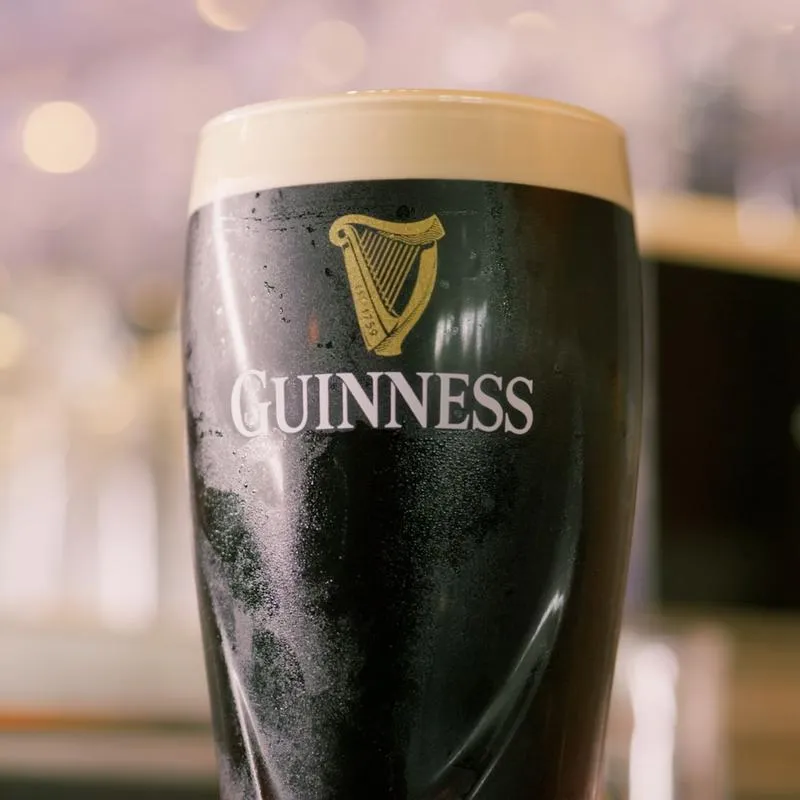 Pint of dark beer in a glass, closeup.