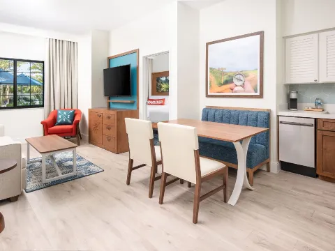 A Living Room With A Table And Chairs