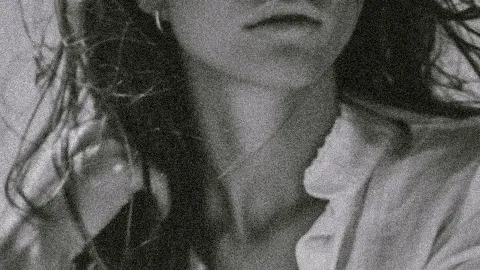 Grainy black and white photo of a person with long hair, slightly open lips, and a partially visible shirt. best Restaurant in West Palm Beach for lunch