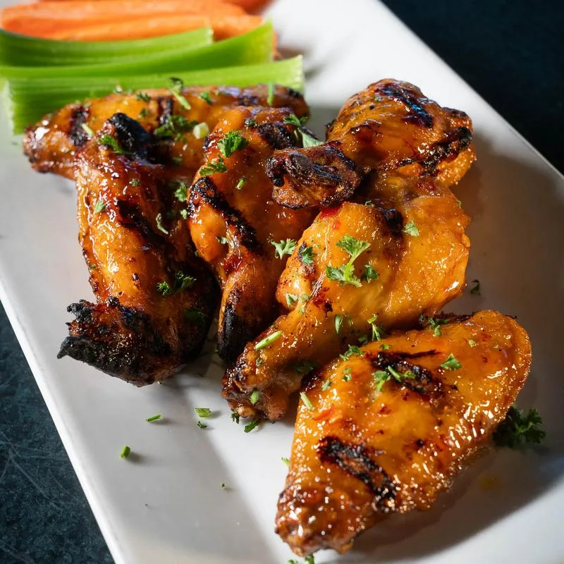 Chicken wings with carrots and celery.