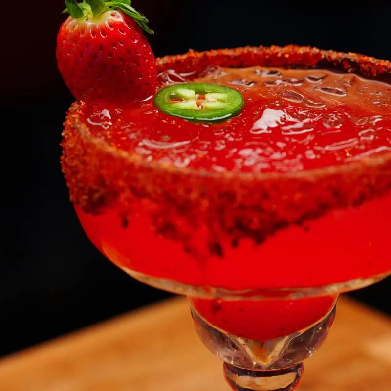 Strawberry Jalapeño Margarita served in a chili-rimmed glass.
