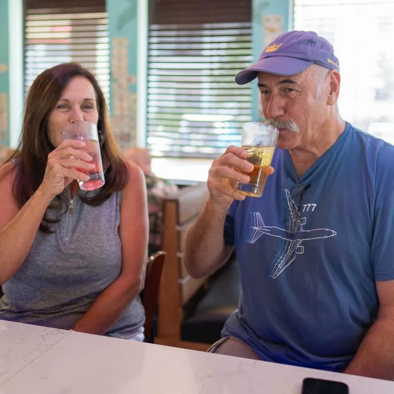 Interior, a couple of guests sipping their drinks at a bar counter.