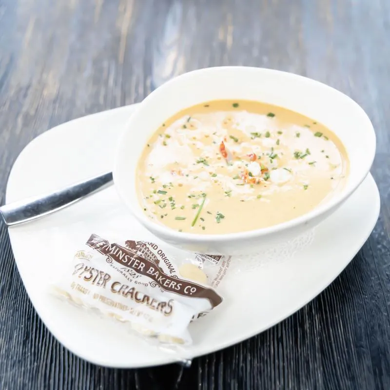 Creamy seafood bisque served with crackers.