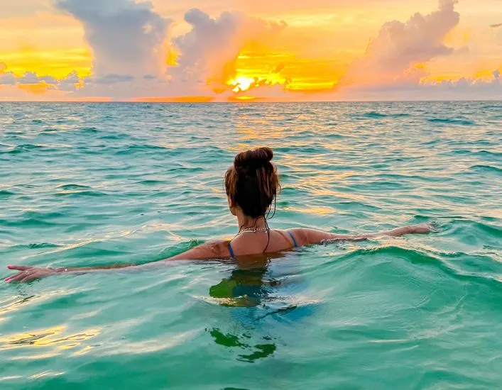 A Woman In A Garment In The Water