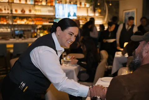 Bartender smiling talking to guest