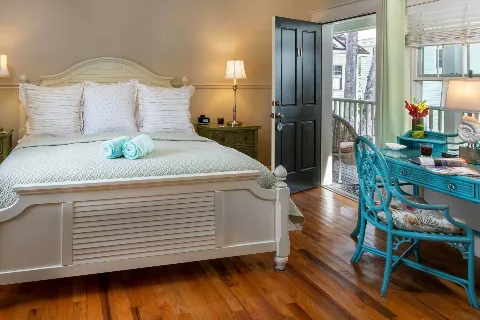 Room 11 bed with desk and open door