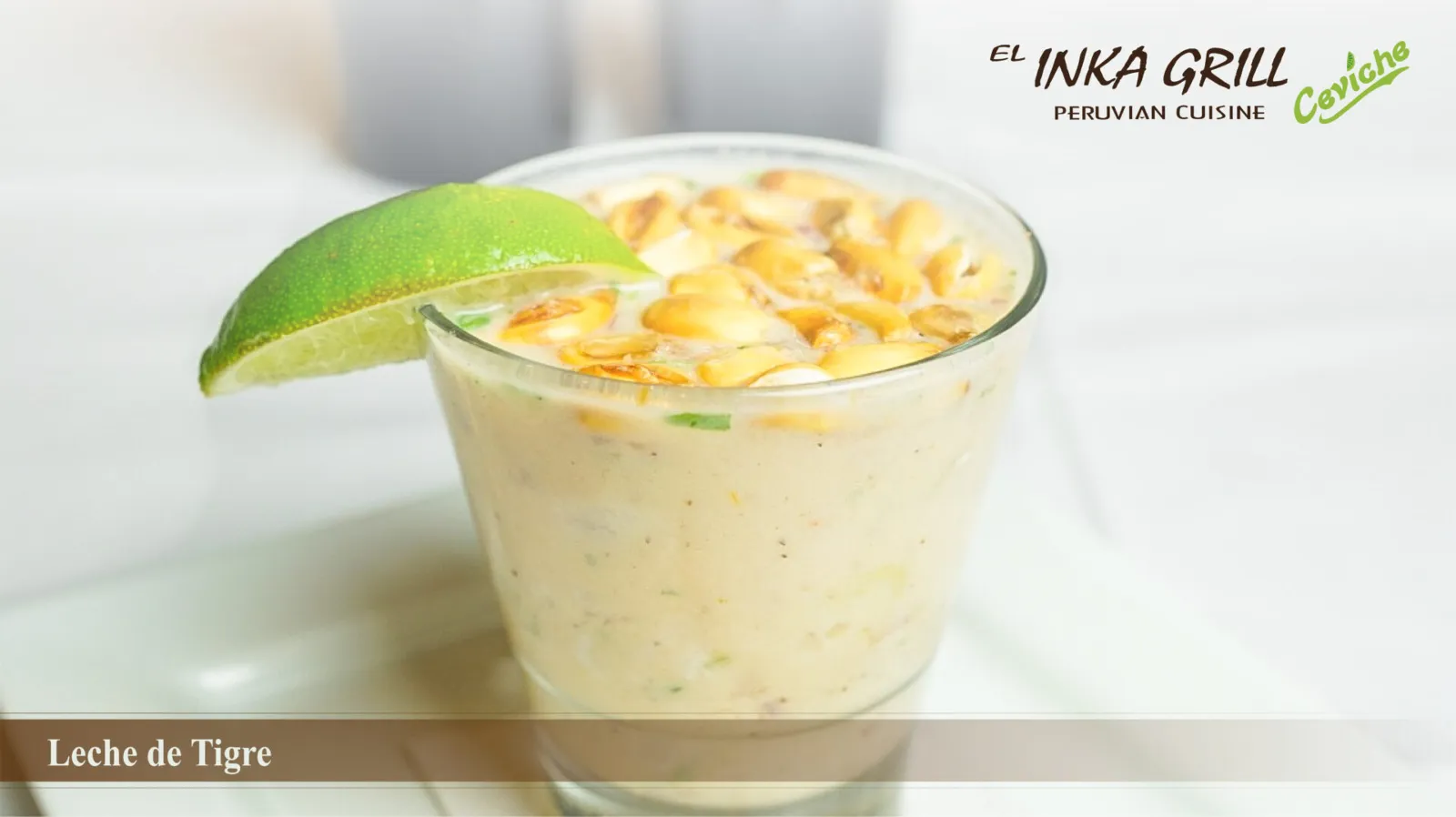 A glass of rice pudding with lime wedge on top.