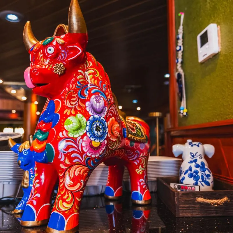 Colorful decorative bull statue on restaurant counter.