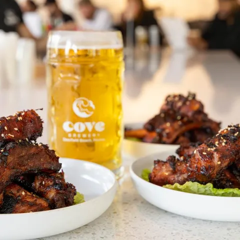 Three plates of Char - Sui Style Spare Ribs served with a beer.