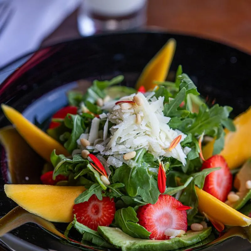 Mango and strawberry salad, mango, arugula, avocado, strawberry, pine nuts, pecorino and honey lemon dressing