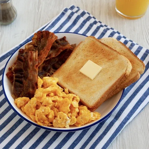 Homemade American Scrambled Egg Breakfast on a Plate, side view.
