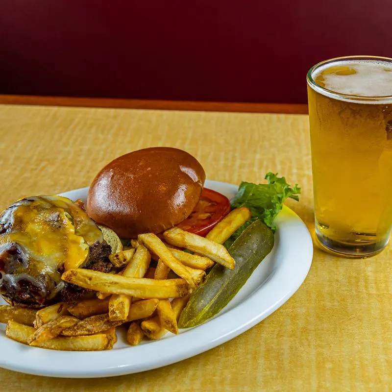 Bacon cheeseburger and a glass of beer.