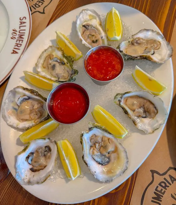 Fresh oysters on ice with lemon and cocktail sauce at Salumeria 104 Weston
