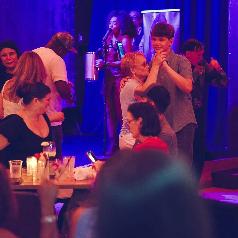 People dancing to live music in a restaurant.