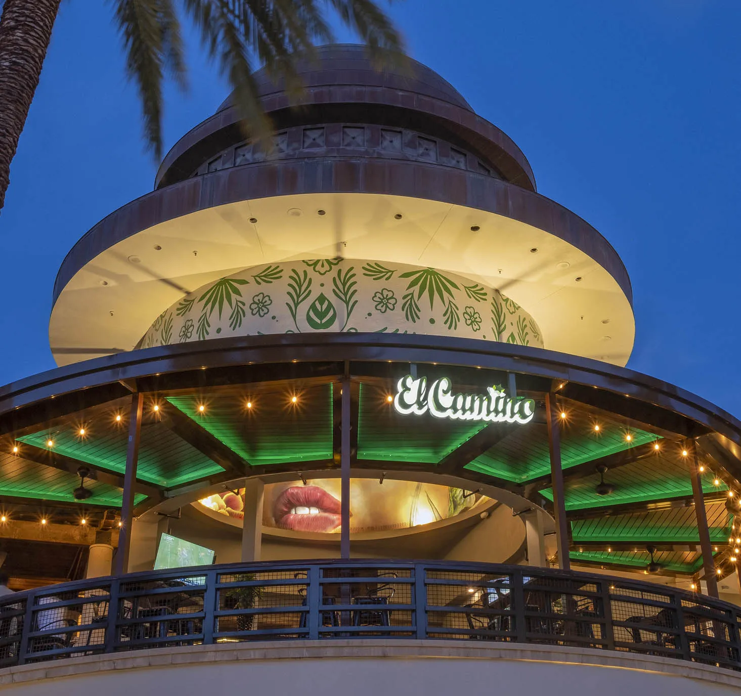 El Camino West Palm Beach dome-shaped rooftop entrance at dusk, illuminated neon sign, string lights, and palm tree in foreground