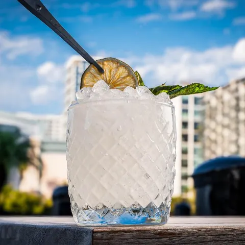 White cocktail with a mint garnish.