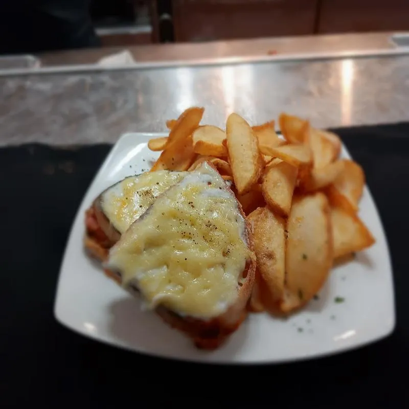 Croque Monsieur sandwich served with fries on the side.
